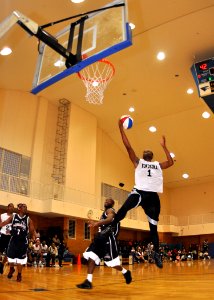 US Navy 091206-N-2013O-614 Electronics Technician 2nd Class Jeremy Haynes, assigned to the Arleigh Burke-class guided-missile destroyer USS Stethem (DDG 63) goes for a lay up during a basketball game photo