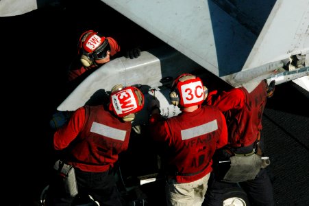 US Navy 091207-N-3327M-120 Sailors load ordnance onto an F-A-18C Hornet assigned to the Warhawks of Strike Fighter Squadron (VFA) 97 aboard the aircraft carrier USS Nimitz (CVN 68) photo