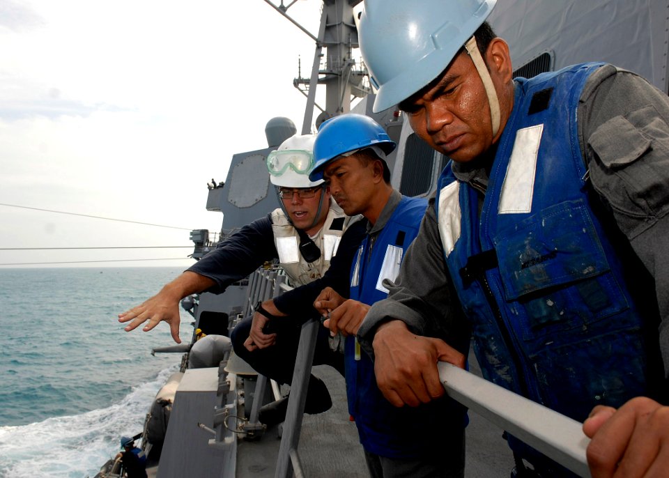 US Navy 091206-N-9520G-054 Ensign Robert A. Thomas shows Chief Petty Officer Abdul Malek Bin Amat Salleh and Petty Officer M. Satar Muhamad procedures of receiving fuel
