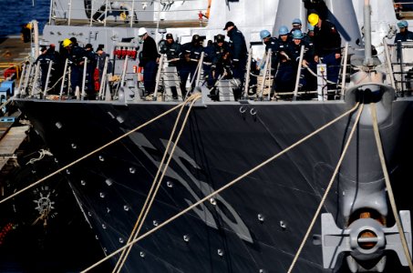 US Navy 091207-N-7280V-117 ailors aboard the Arleigh Burke-class guided-missile destroyer USS John S. McCain (DDG 56) take in lines before getting underway