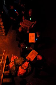 US Navy 091212-N-0260R-279 Sailors move stores from pallets transferred from USNS Kanawha (T-AO 196)