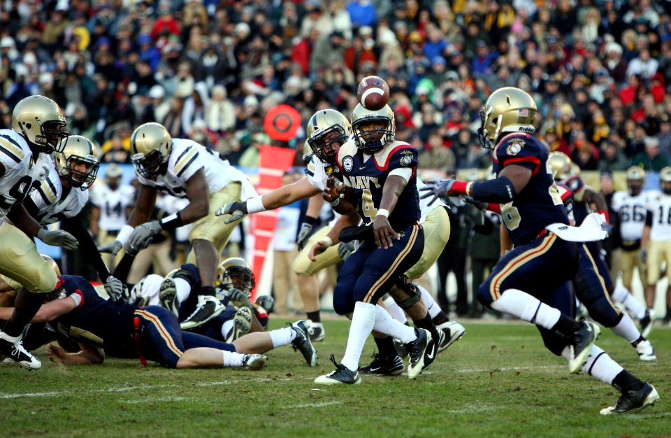 US Navy 091212-N-4936C-580 Navy quarterback Ricky Dobbs (^4) pitches the ball to slot back Marcus Curry (^28) during the 110th Army-Navy college football game at Lincoln Financial Field in Philadelphia