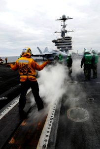 US Navy 091209-N-9928E-231 Aviation Boatswain's Mate (Handling) 3rd Class Scott Gray, from Salt Lake City, directs an F-A-18F Super Hornet