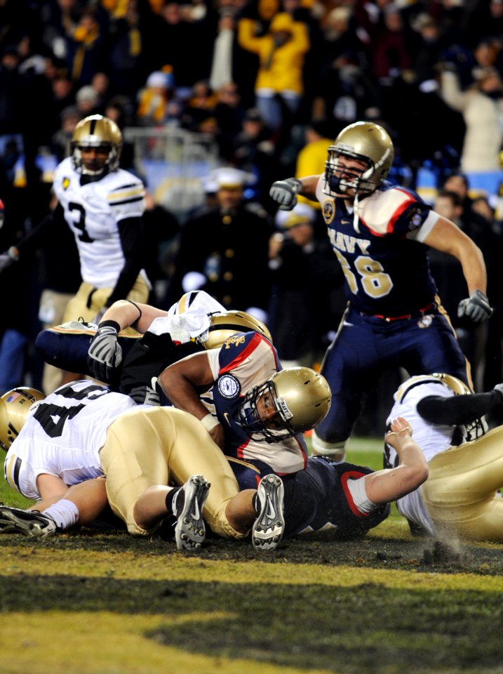 US Navy 091212-N-9693M-582 Navy quarterback Ricky Dobbs (^4) scores a touchdown on a 1-yard run in the fourth quarter of the 110th Army-Navy college football game at Lincoln Financial Field in Philadelphia