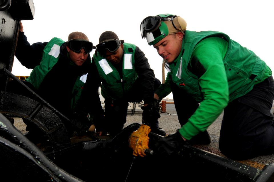 US Navy 091208-N-4275C-001 Aviation Boatswain's Mate (Equipment) Airman Andrew Elvir, stows barricade equipment with the help of Aviation Boatswain's Mate (Equipment) 3rd Class Daverris Culpepper