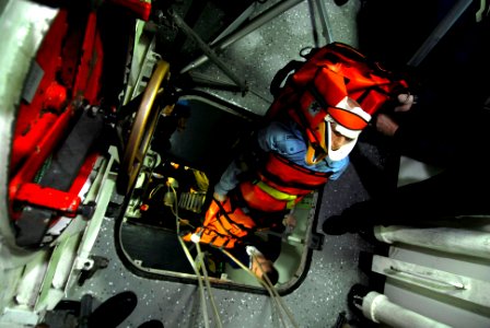 US Navy 091210-N-2475A-237 lying squad members and hospital corpsmen hoist a simulated casualty out of a trunk during a deep extraction drill aboard the Nimitz-class aircraft carrier USS John C. Stennis (CVN 74)