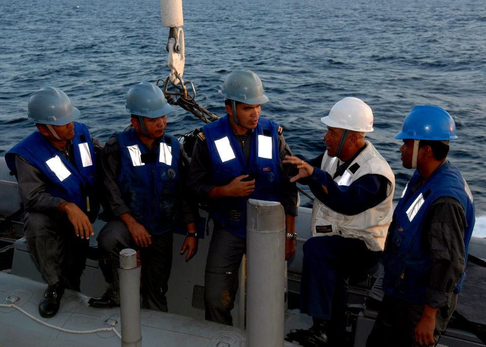 US Navy 091207-N-9520G-070 Chief Boatswain's Mate Jose M.P. Bayuga explains man overboard procedures with sailors from the Royal Malaysian Navy