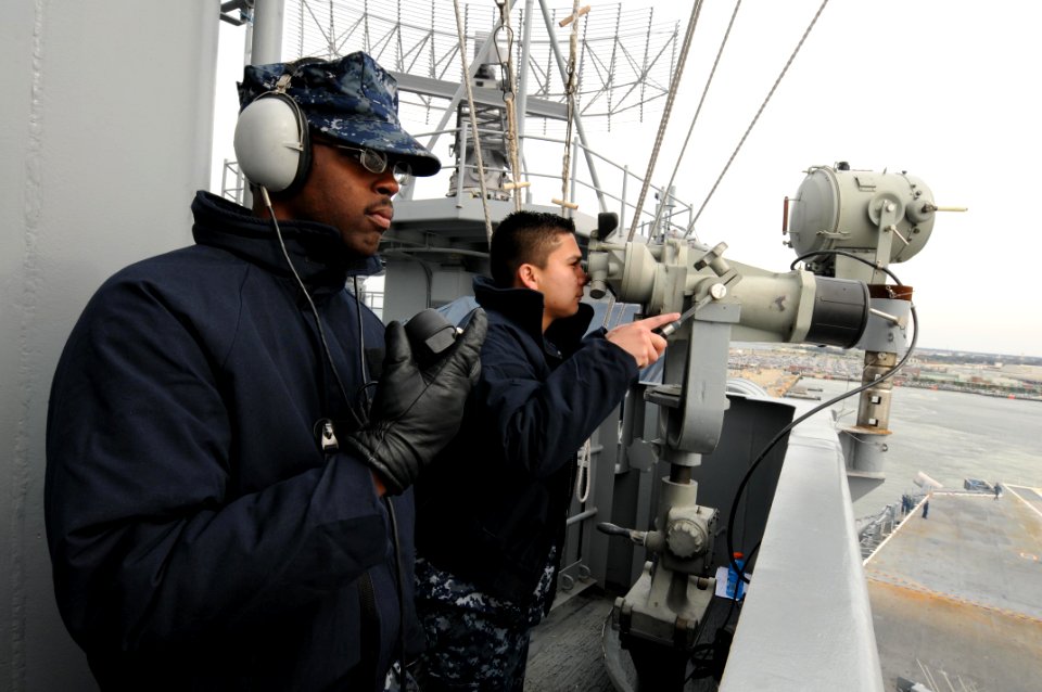 US Navy 091208-N-4275C-041 Operations Specialist 3rd Class Milton Bobbitt, left, and Operations Specialist 3rd Class Jesus Rangel stand the port aft lookout watch aboard the aircraft carrier USS Carl Vinson as the ship gets und