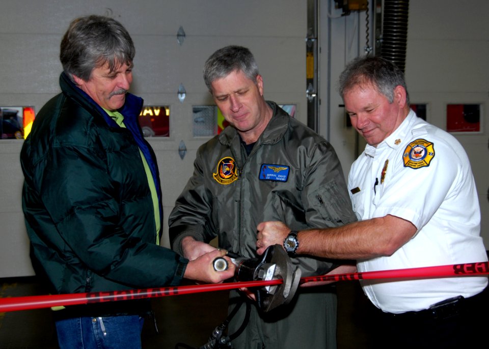 US Navy 091215-N-9860Y-003 Capt. Gerral David, John Hodges and Chief John Arruda perform a ribbon-cutting with the Jaws of Life during a reopening ceremony for the Navy Region Nortwest Fire and Emergency Services Fire Station 7