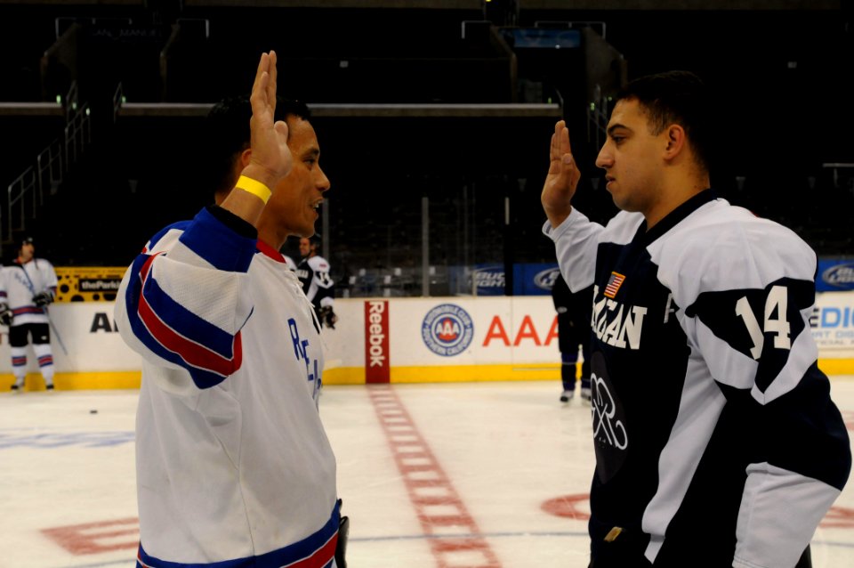 US Navy 091207-N-9132C-084 Cmdr. Art Delacruz, left, reenlists Aviation Structural Mechanic 2nd Class Darwin Buss on the ice