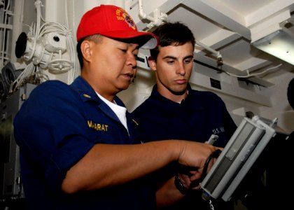 US Navy 091211-N-9520G-035 Chief Logistics Specialist Clyde Maarat shows Seaman Adam Komperda a chemical, biological and radiological drill radiation test kit