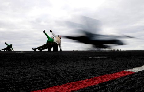 US Navy 091209-N-9928E-320 Marines assigned to the Sharpshooters of Marine Fighter Attack Training Squadron (VMFAT) 101 launch an F-A-18C Hornet from the Nimitz-class aircraft carrier USS John C. Stennis (CVN 74)