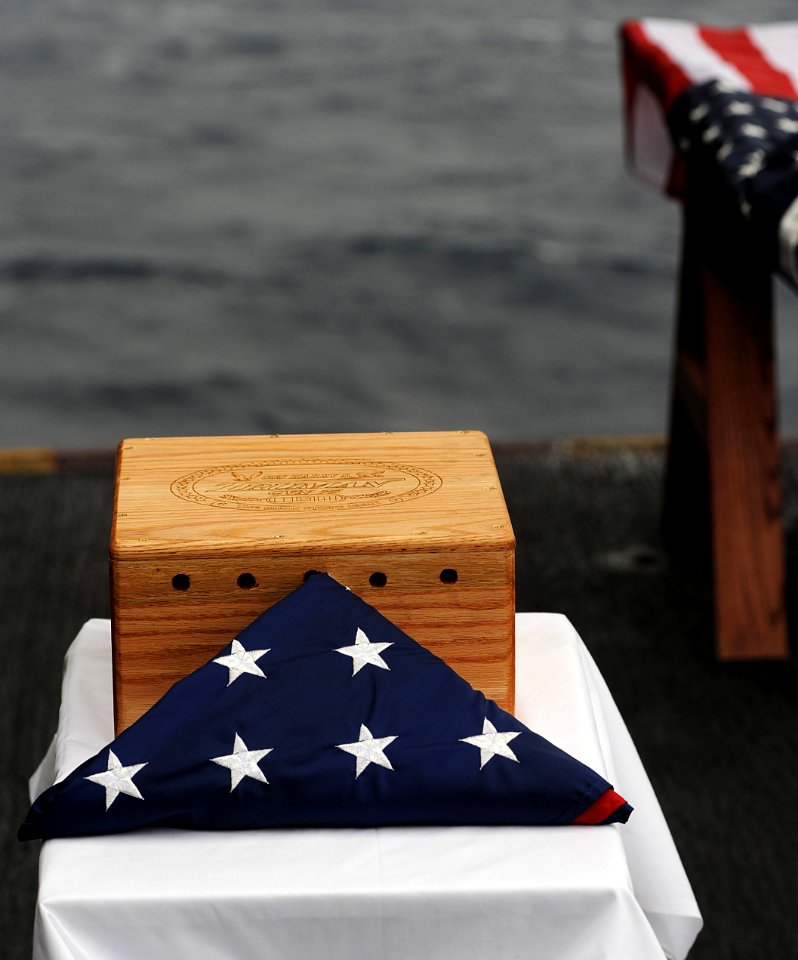US Navy 091210-N-7317W-002 The remains of Seaman 1st Class John Fox, a World War II veteran, lay beside an American Flag during his burial at sea ceremony