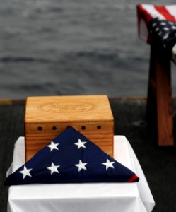 US Navy 091210-N-7317W-002 The remains of Seaman 1st Class John Fox, a World War II veteran, lay beside an American Flag during his burial at sea ceremony