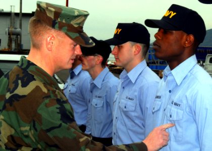 US Navy 091209-N-5538K-183 Master-at-Arms 1st Class Christopher Williams conducts a uniform inspection on prospective 3rd Class petty officers