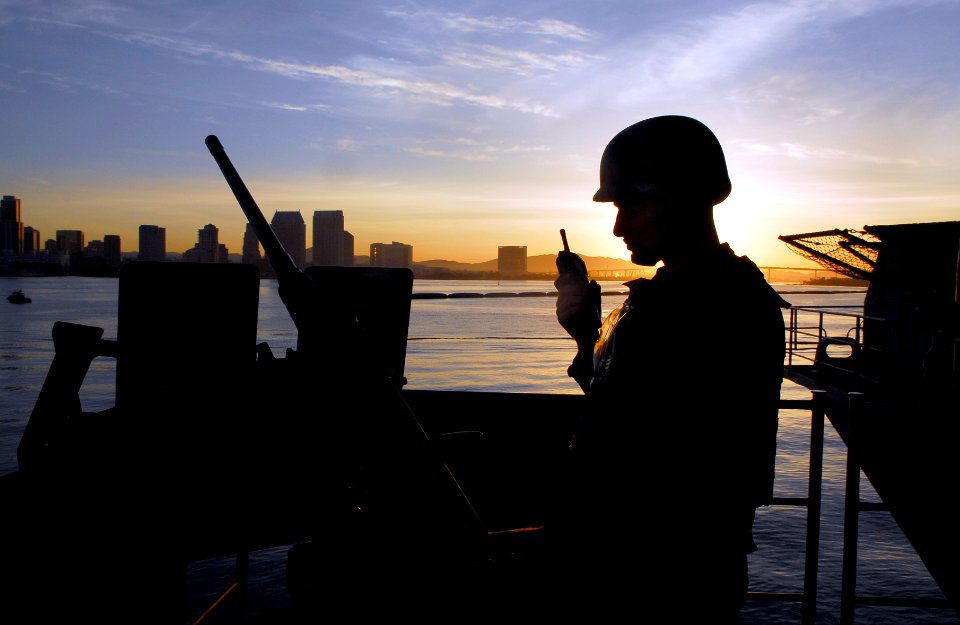 US Navy 091215-N-2475A-043 Gunner's Mate 3rd Class Jonathan Vargo, from Jacksonville, Fla., radios the gunner's liaison officer