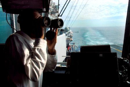 US Navy 091210-N-2475A-084 Aviation Boatswain's Mate (Handling) Airman Charrell Booth, from Laplace, La., checks for incoming aircraft from the aft spotter watch station in primary flight control aboard the Nimitz-class aircraf
