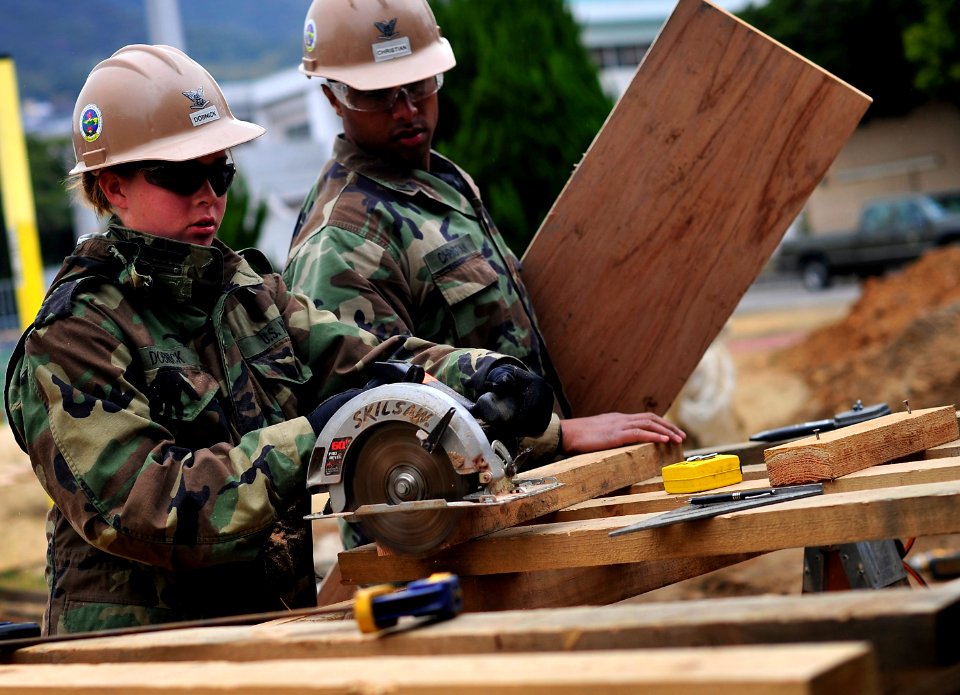 US Navy 091217-N-0807W-127 Utilitiesman Constructionman Kaytln Dobnick uses a circular saw to cut lumber for a construction project