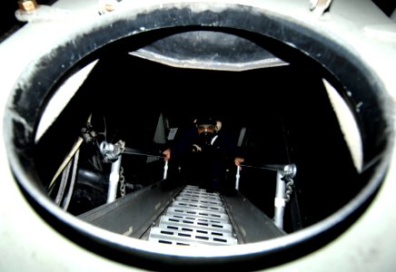 US Navy 091213-N-3793B-022 A Sailor climbs a ladder while participating in a chemical, biological, and radiological drill