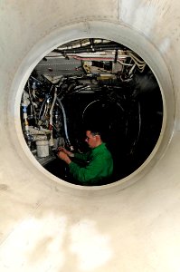US Navy 091212-N-3038W-040 Aviation Electrician's Mate 3rd Class Terry Ward performs maintenance on the wiring harness of an EA-6B Prowler
