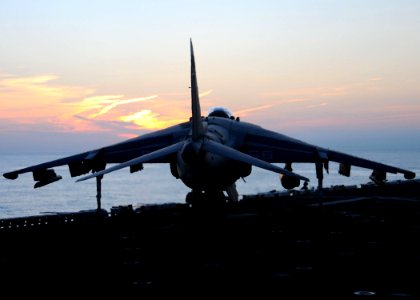 US Navy 091214-N-2735T-159 An AV-8B Harrier II jet maneuvers around the flight deck of USS Nassau (LHA 4)