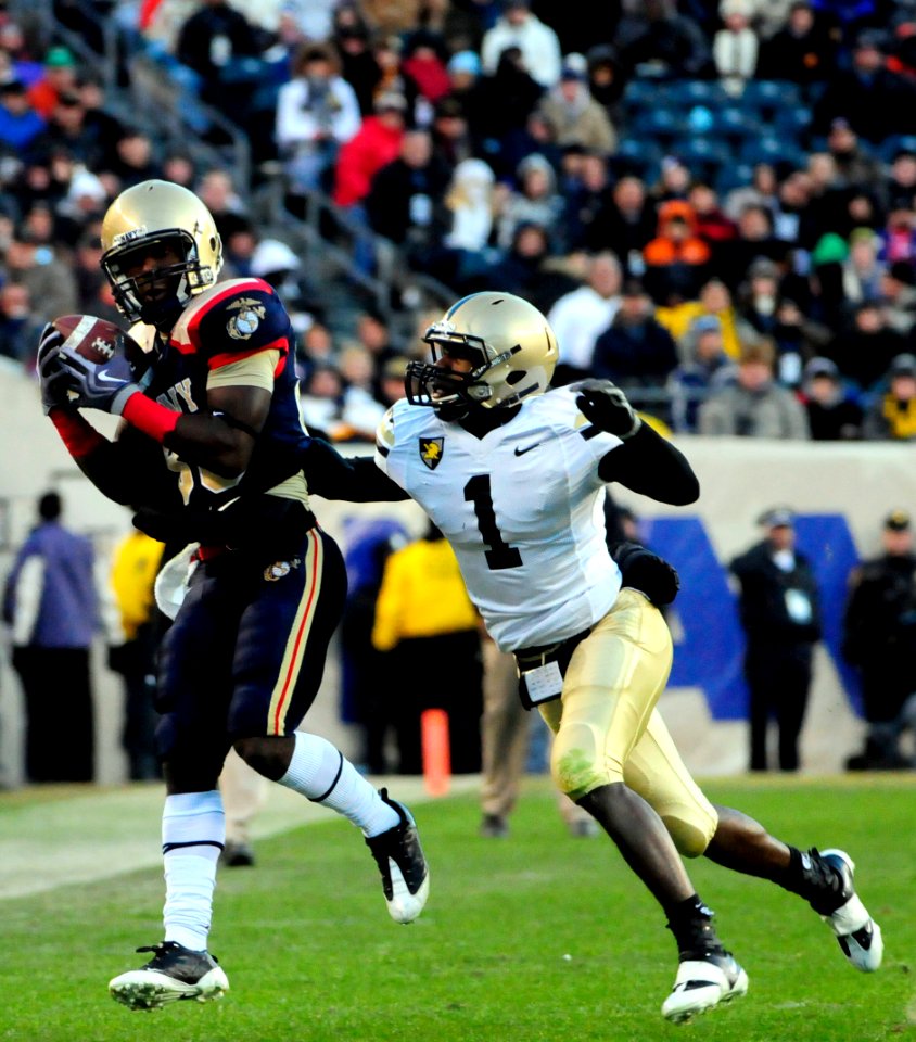 US Navy 091212-N-9693M-627 Navy wide receiver Mario Washington (^85) brings down a catch against Army defensive back Mario Hill (^1) for a first down