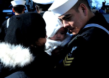 US Navy 091222-N-6764G-076 Damage Controlman 1st Class Lawrence Madrid is reunited with his wife after returning from a three month deployment