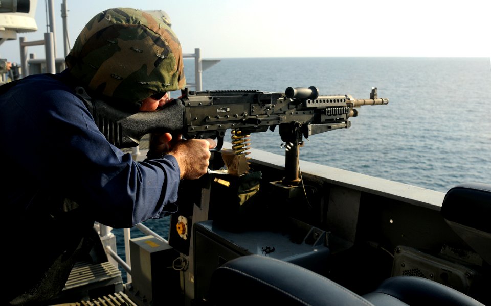 US Navy 091227-N-1291E-214 A Sailor aboard the guided-missile cruiser USS Chosin (CG 65) conducts target practice with an M240B machine gun