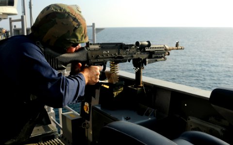 US Navy 091227-N-1291E-214 A Sailor aboard the guided-missile cruiser USS Chosin (CG 65) conducts target practice with an M240B machine gun