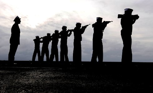 US Navy 091213-N-9928E-101 Sailors render a rifle volley during a burial at sea ceremony aboard the aircraft carrier USS John C. Stennis (CVN 74)