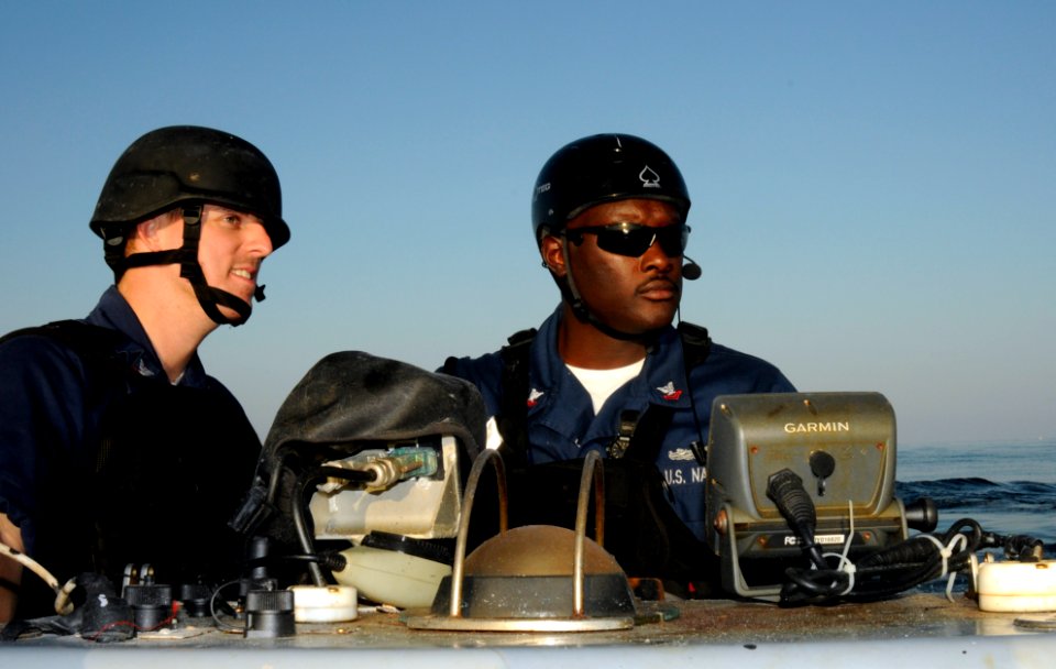 US Navy 100101-N-1291E-132 Engineman 3rd Class Steven Becker, left, and Boatswain's Mate 2nd Class Christopher Black transport members of a visit, board, search and seizure team