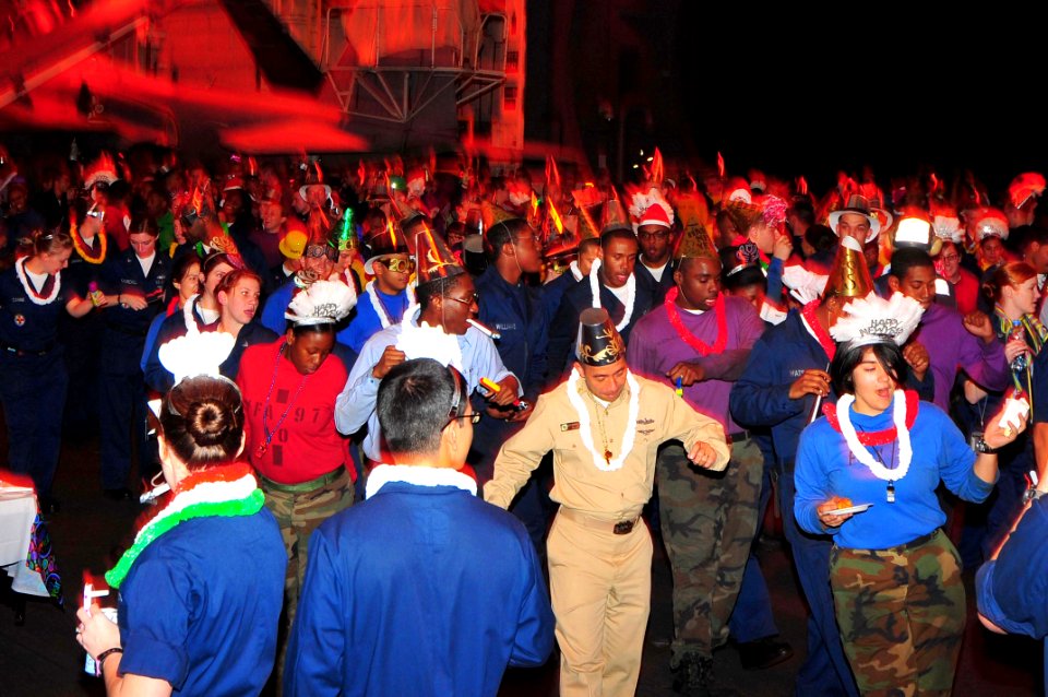 US Navy 100101-N-4053P-005 Sailors celebrate New Years in the ship's hangar bay aboard the aircraft carrier USS Nimitz (CVN 68)