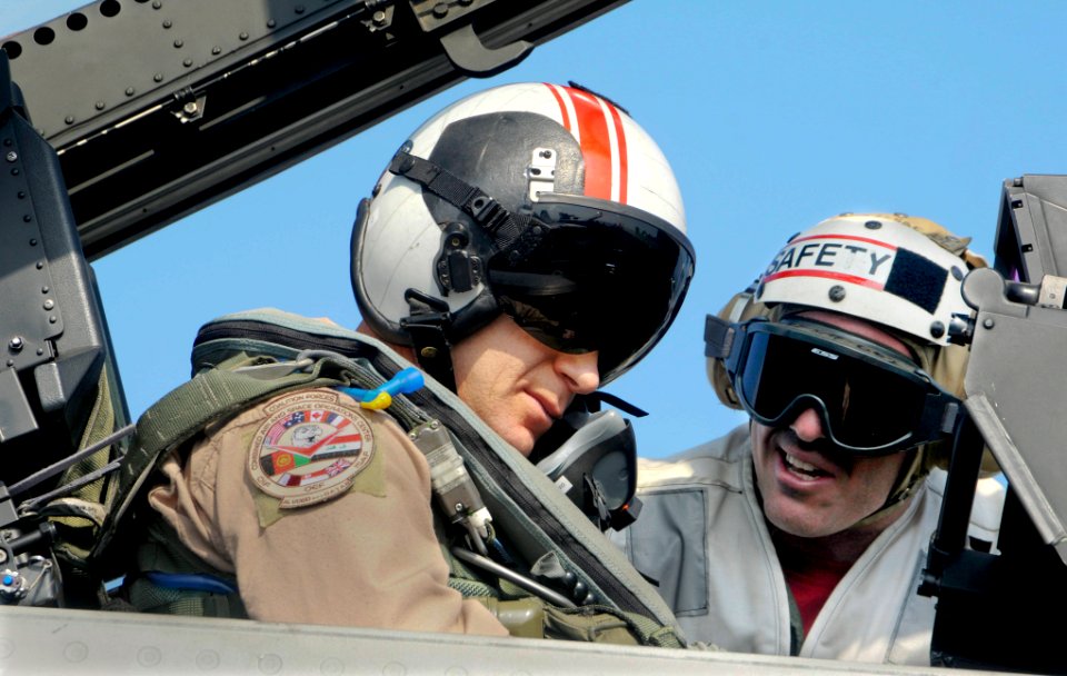 US Navy 100101-N-3038W-899 Gen. Mark W. Graper, director of the Combined Air and Space Operations Command Center, is briefed by Lt. Cmdr. Bill Fallon