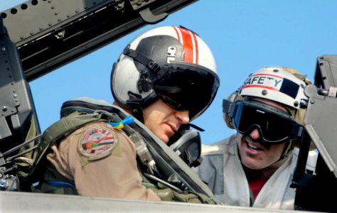 US Navy 100101-N-3038W-899 Gen. Mark W. Graper, director of the Combined Air and Space Operations Command Center, is briefed by Lt. Cmdr. Bill Fallon
