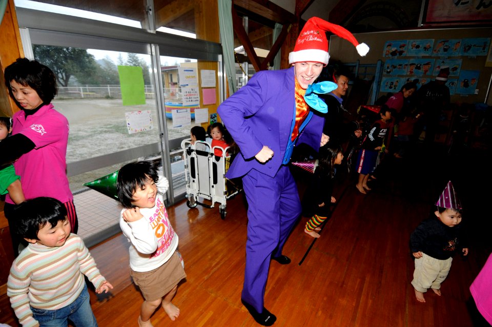 US Navy 091218-N-8335D-232 Master-at-Arms 3rd Class Paul Ellis dances with children at the Kusuzumi daycare center