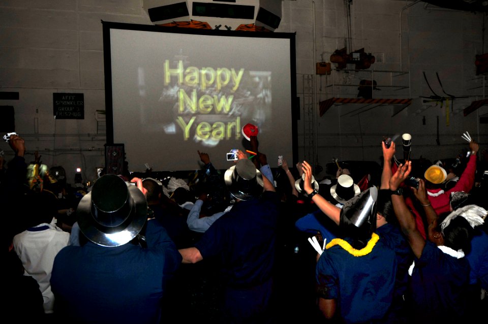 US Navy 100101-N-4053P-013 Sailors celebrate the arrival of the New Year in the ship's hangar bay aboard the aircraft carrier USS Nimitz (CVN 68)