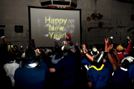 US Navy 100101-N-4053P-013 Sailors celebrate the arrival of the New Year in the ship's hangar bay aboard the aircraft carrier USS Nimitz (CVN 68)