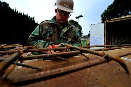 US Navy 091217-N-0807W-062 Steelworker Constructionman Sean Hatchett ties together steel rebar to increase tensile strength and reinforce concrete