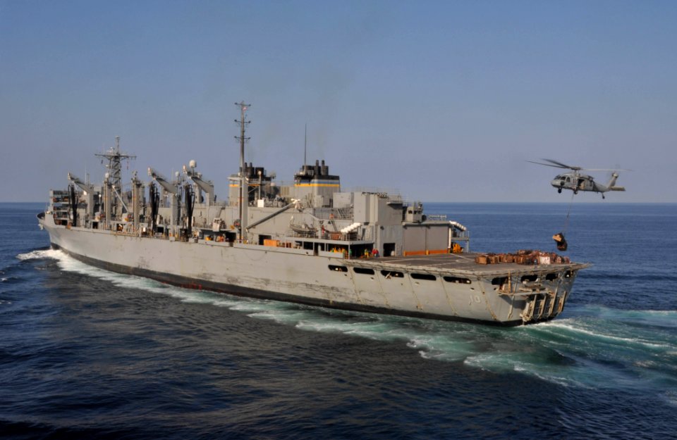 US Navy 091217-N-8421M-006 An MH-60S Sea Hawk helicopter assigned to the Wildcards of Helicopter Sea Combat Squadron (HSC) 23, delivers pallets to the Military Sealift Command fast combat support ship USNS Bridge (T-AOE 10)