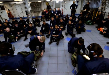 US Navy 091213-N-6003P-029 Sailors are trained on the donning of chemical protective gear at the mess decks during a general quarters