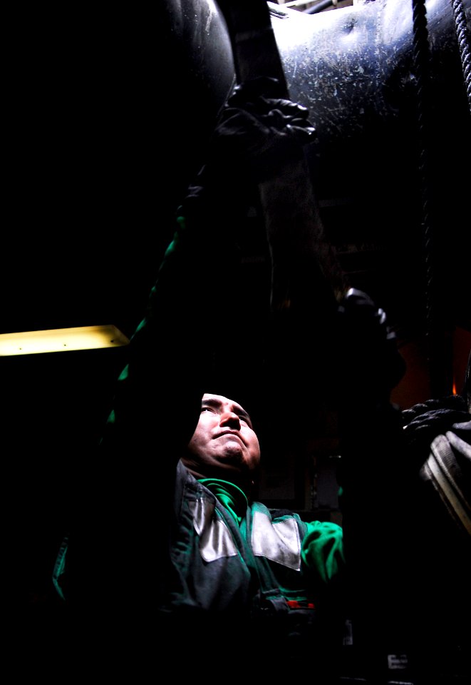 US Navy 091217-N-6046S-001 Aviation Boatswain's Mate (Equipment) 3rd Class Lawrence Jones, from Deering, Ala., stows gear from the flight deck in an arresting gear shop aboard the Nimitz-class aircraft carrier USS John C. Stenn