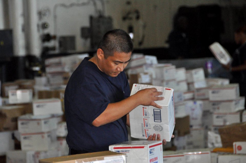 US Navy 091217-N-8421M-009 Yeoman 2nd Class Randy Paradeza sorts mail aboard the aircraft carrier USS Nimitz (CVN 68) during a replenishment at sea