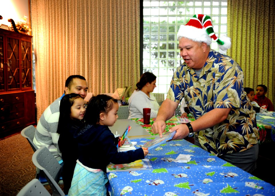US Navy 091214-N-6326B-029 Master Chief Hospital Corpsman Jeff Apana hands out gifts to the children of staff from Naval Medical Center San Diego