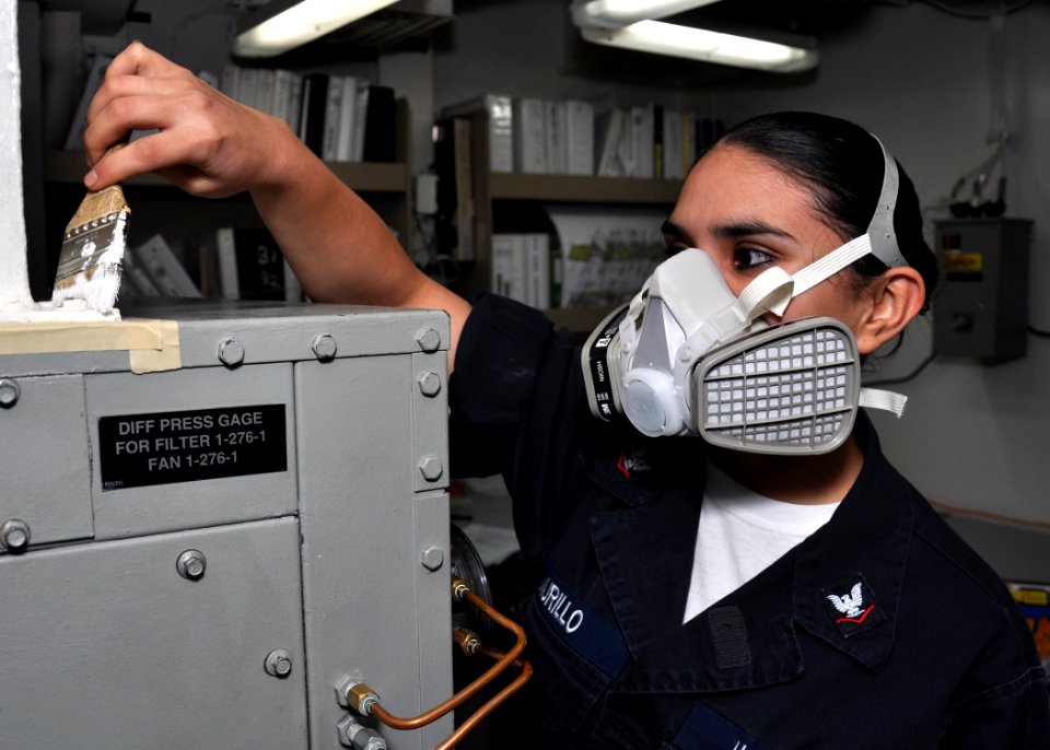 US Navy 091228-N-2013O-040 Gas Turbine System Technician (Electrical) 3rd Class Alejndra Murillo, from Las Vegas, paints an air conditioning unit while conducting ship preservation aboard the Arleigh Burke-class guided-missile