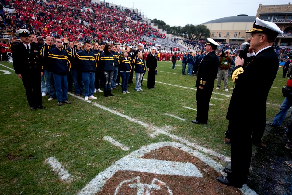US Navy 091231-N-0696M-128 Adm. Mike Mullen, chairman of the Joint Chiefs of Staff, enlists 125 new service members at the 7th annual Bell Helicopter Armed Forces Bowl at Amon G. Carter Stadium in Fort Worth, Texas
