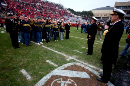US Navy 091231-N-0696M-128 Adm. Mike Mullen, chairman of the Joint Chiefs of Staff, enlists 125 new service members at the 7th annual Bell Helicopter Armed Forces Bowl at Amon G. Carter Stadium in Fort Worth, Texas