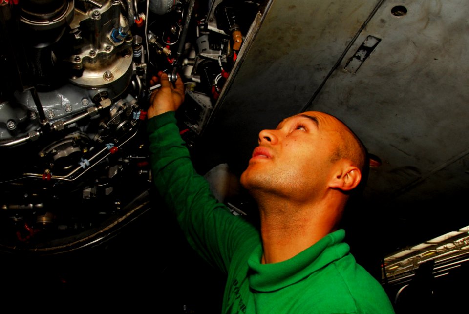 US Navy 100107-N-3327M-028 Aviation Machinist's Mate 1st Class Cosme Beltran performs maintenance on an EA-6B Prowler aboard USS Nimitz (CVN 68)