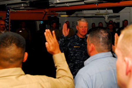 US Navy 100106-N-3327M-168(1) Chief of Naval Operations (CNO) Adm. Gary Roughead recites the oath of reenlistment to Sailors during a reenlistment