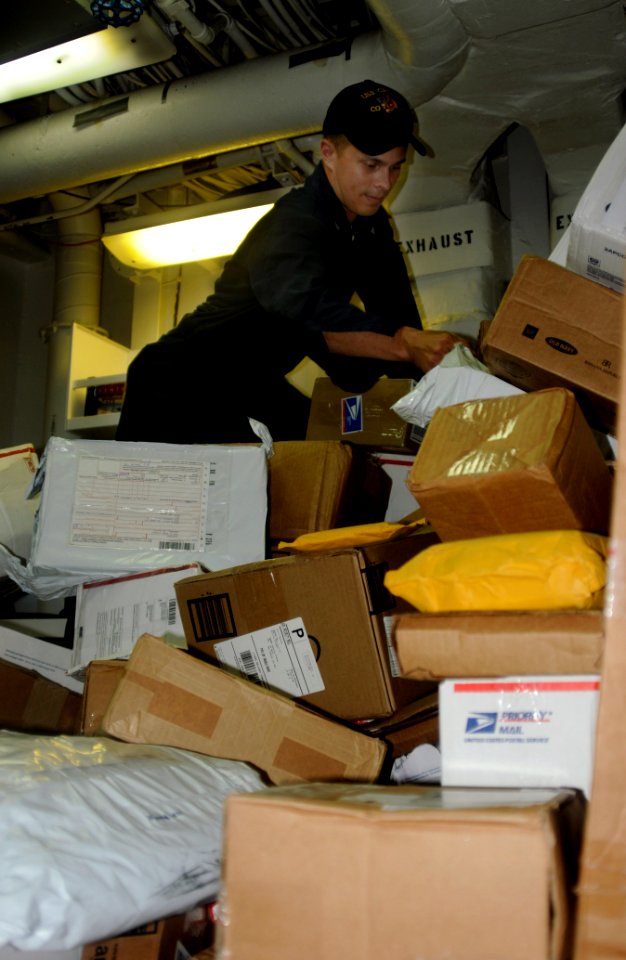 US Navy 091226-N-1291E-013 Gas Turbine Mechanical 3rd Class Brian Bogema sorts holiday mail aboard the guided-missile cruiser USS Chosin (CG 65)