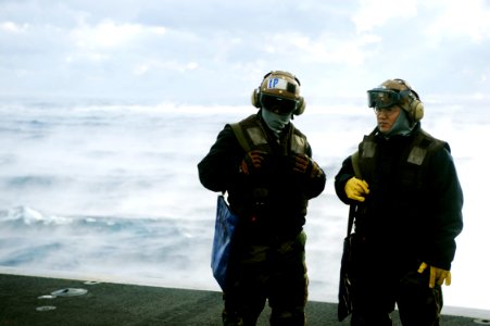 US Navy 100103-N-6604E-056 Aviation Structural Mechanic Airman Jung Hwong and Aviation Electrician's Mate Airman Elijah Vasquez prepare for a foreign object debris walk down before flight operations aboard the aircraft carrier